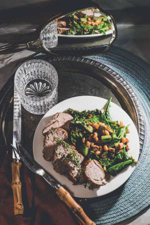 Roasted pork tenderloin with collard green black eyed pea saladの写真素材