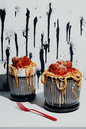 Italian spaghetti and meatballs in marinara sauce with abstract paint drip background patternの写真素材