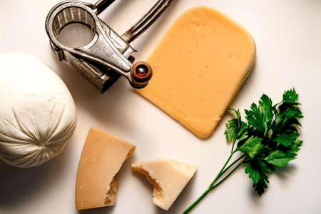 Various cheeses aranged on cutting board during dinner preparation