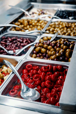 Close up of fresh Italian olive bar red hot cherry peppers self serveの写真素材