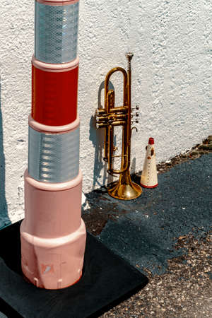 Summer jazz instrument trumpet standing alone against building
