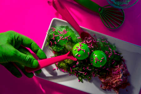 Science fiction green alien from outer space eating dinner at a fancy neon nightclub
