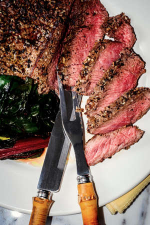 Rare steak with everything bagel seasoning served with red swiss chard
