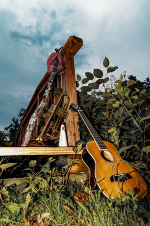 Traveling musicians trumpet ukulele and handkerchief picnic sack on a stickの写真素材