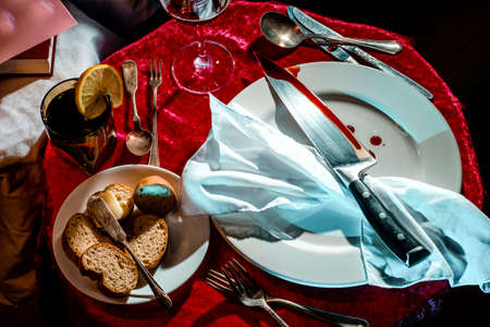 Macabre murder mystery dinner party event with bloody knife