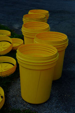 Several empty garbage cans at the end of the driveway