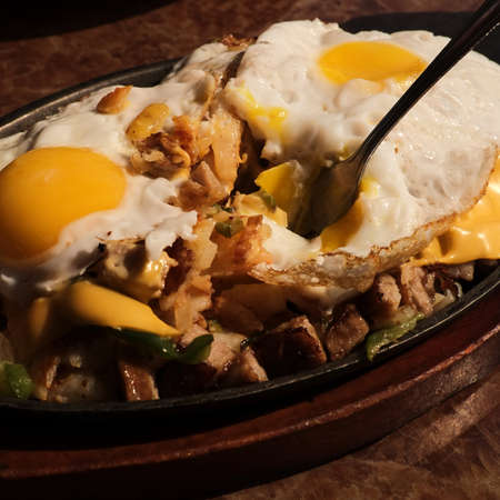 Sausage and eggs breakfast skillet with toast and orange juiceの写真素材