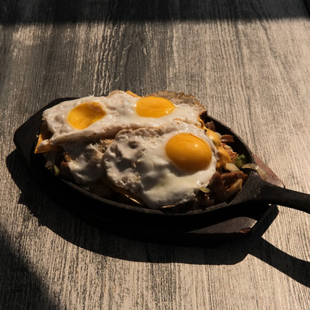 Sausage and eggs breakfast skillet with toast and orange juiceの写真素材