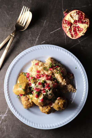 Turkish meatballs in curry hummus sauce with quinoa and pomegranate berriesの写真素材
