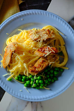 Italian chicken fettuccine alfredo with green peasの写真素材