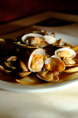 Chinese baby clams on the shell with black bean sauceの写真素材