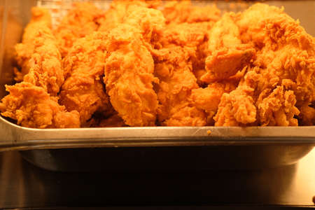 Closeup fried chicken wings buffet station cooling rackの写真素材