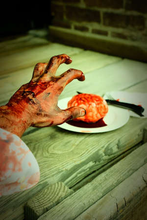 Bloody zombie hand reaching for fresh brains to eat for dinnerの写真素材
