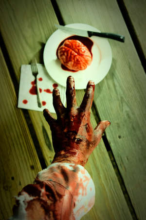 Bloody zombie hand reaching for fresh brains to eat for dinnerの写真素材