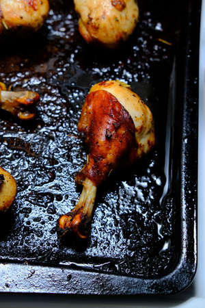 Crispy oven baked chicken legs cooling on pan
