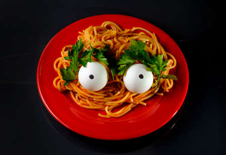 Spaghetti alien monster with eyeballs scared of being eatenの写真素材