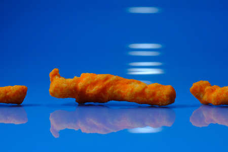 Cheese puff unhealthy junk food snack macro closeup