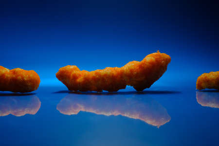 Cheese puff unhealthy junk food snack macro closeup