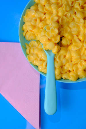 Kids fun seashell pasta mac and cheese served in plastic plateの写真素材