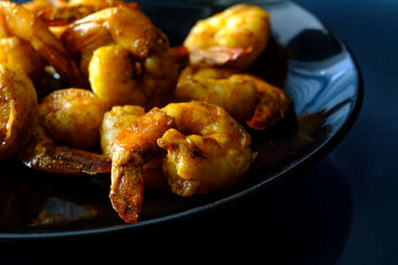 Spicy tail-on cajun shrimp dinner or appetizer  with dark moody lightingの写真素材