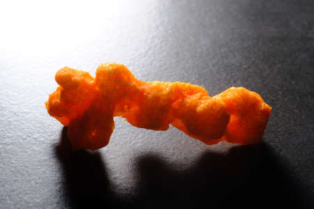 Cheese puff unhealthy junk food snack macro closeupの写真素材