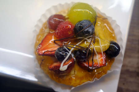 Mini fresh fruit tart on display at local bakery dessert shop