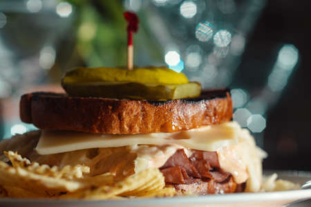 Roast beef and swiss cheese sandwich with cole slaw and dill pickleの写真素材