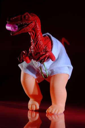 Raptor baby in diaper as metaphor concept for the difficulties of parenting and dealing with young childrenの写真素材