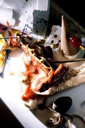 Hot dog and icecream cone mess after fun barbecue partyの写真素材