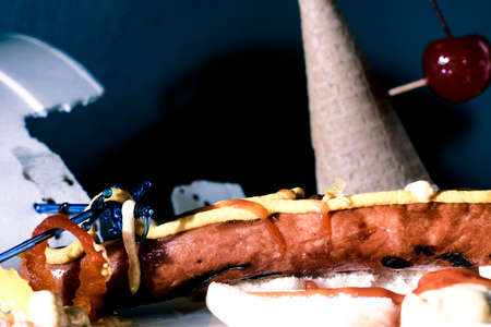 Hot dog and icecream cone mess after fun barbecue partyの写真素材