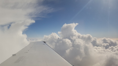 Flying above the clouds in the sun