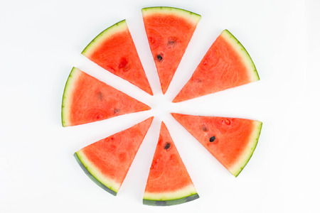 Fresh sliced red watermelon with seeds forming a circle pattern isolated.の写真素材