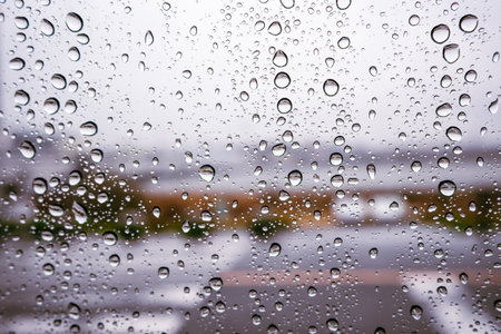 Rainy day day water on the car windshield at the crosswalk