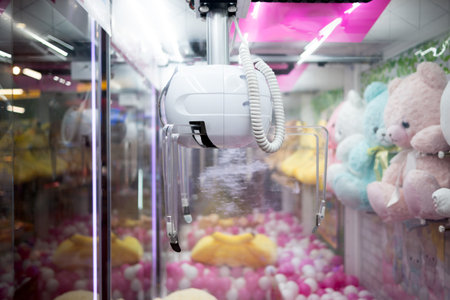 Claw machine crane game catcher at an arcade amusement game center.