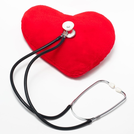 Red plush heart and stethoscope on a white backgroundの写真素材