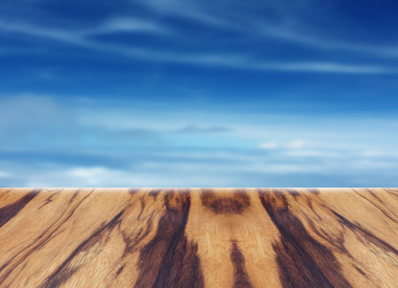 wooden table with blurred sky for backgroundの写真素材