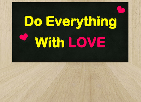 Do everything with LOVE word on wooden backgroundの写真素材