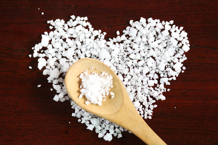 Sea salt with heart style on wooden tableの写真素材