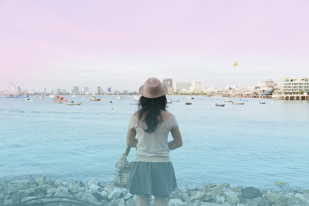 back of woman looking the sea, pastel toneの写真素材
