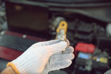 hand holding car repair tools in garage