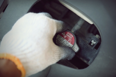 hand holding car repair tools in garageの写真素材