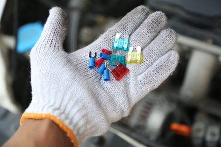 hand holding car repair tools in garageの写真素材