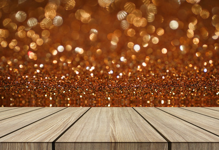 wooden floor on orange brown glitter bokeh texture abstract background