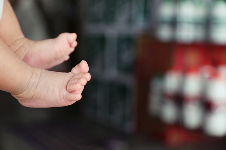 mama holding baby's hand and foot, play with baby.の写真素材