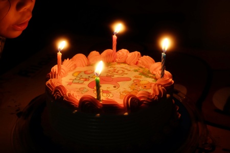 sweet cake with four candlesの写真素材