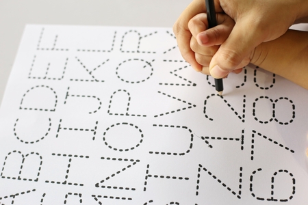 children hand writing ABC