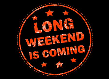 Long weekend is coming grunge rubber stamp on black backgroundの写真素材