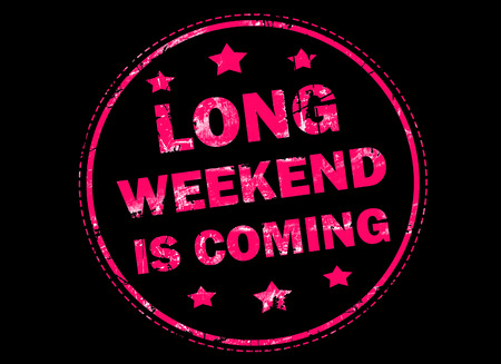 Long weekend is coming grunge rubber stamp on black backgroundの写真素材