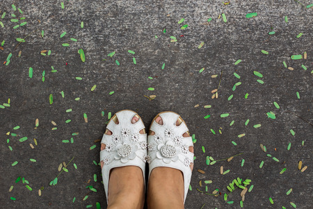 white lady shoes on isolate concrete background with copyspaceの写真素材