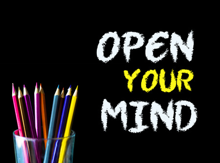 Color pencil on black background with word: OPEN YOUR MINDの写真素材